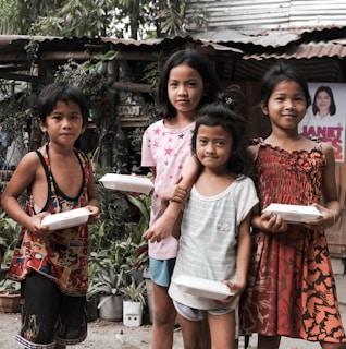 a group of young children standing next to each other