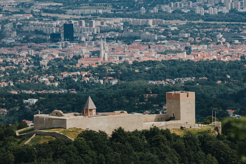 a large castle sitting on top of a lush green hillside