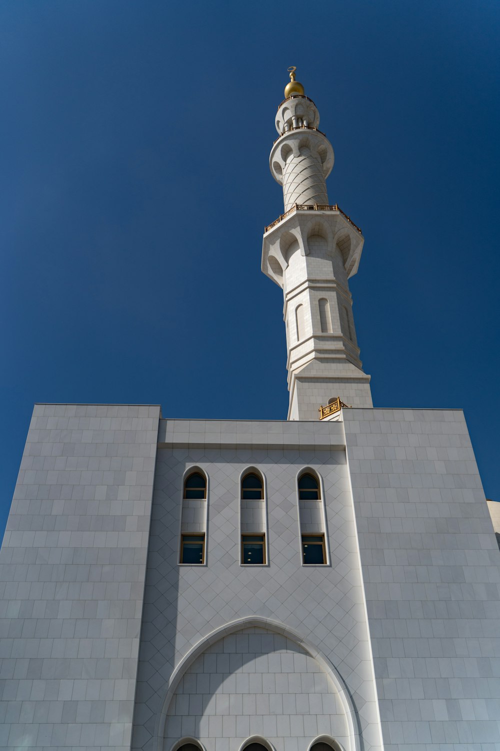 a tall white building with a clock on it's side