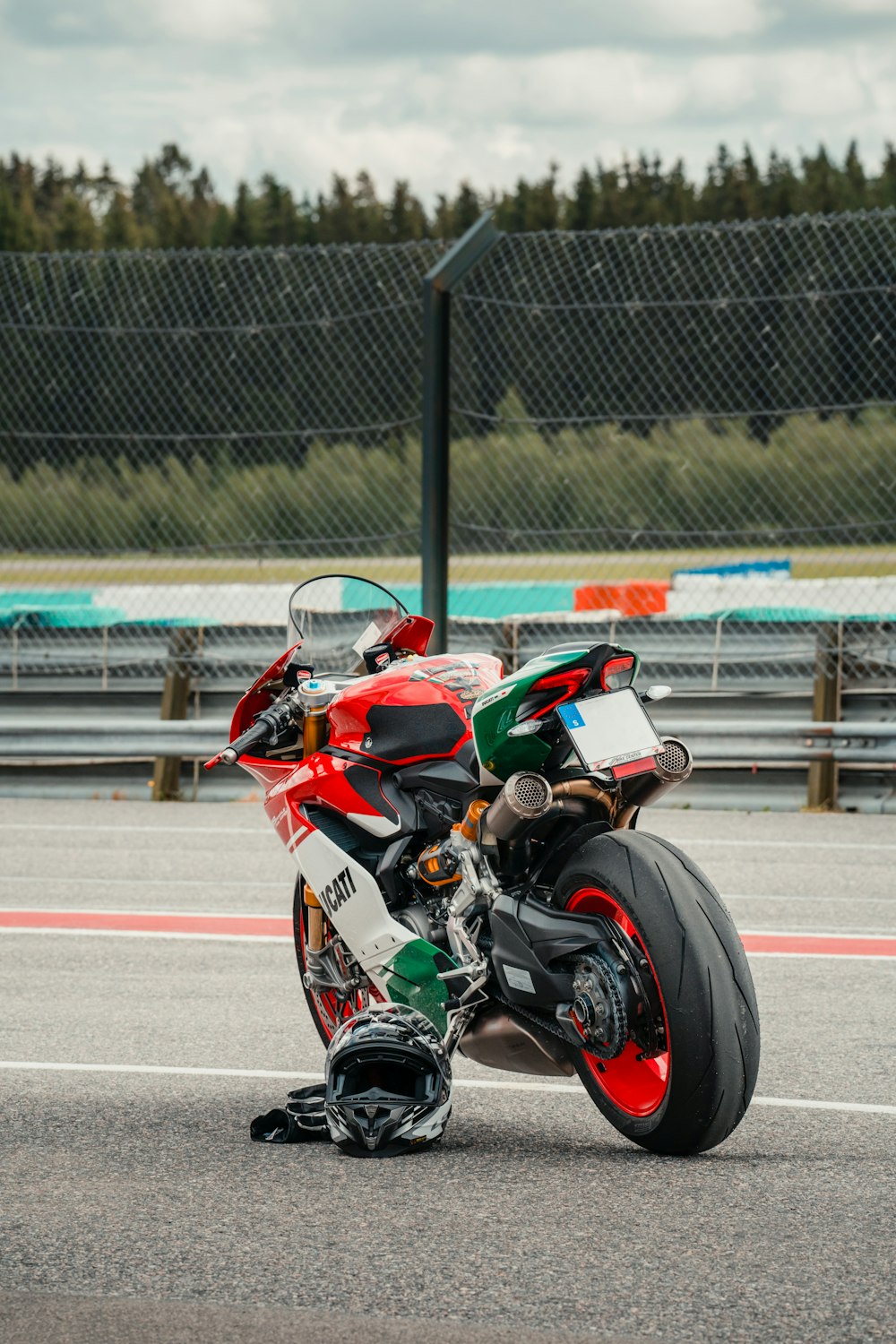 a red and green motorcycle parked on a race track