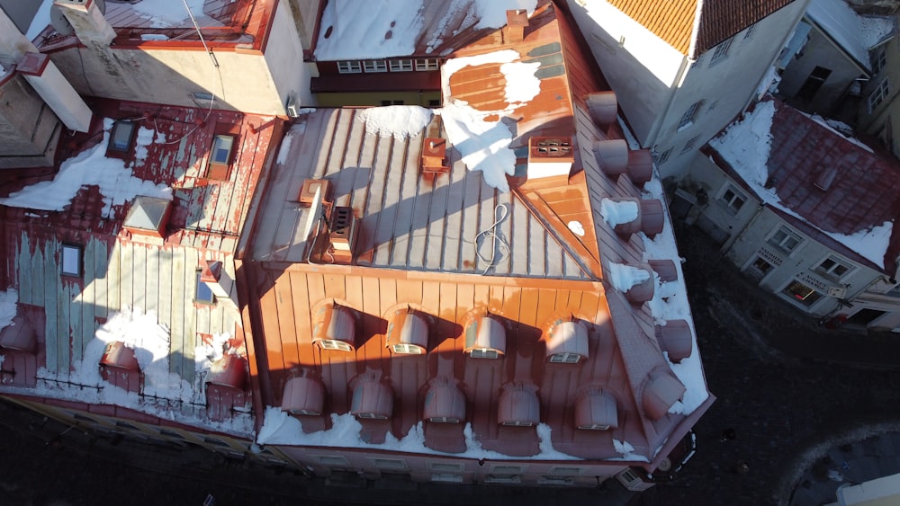 an aerial view of a building with snow on the roof