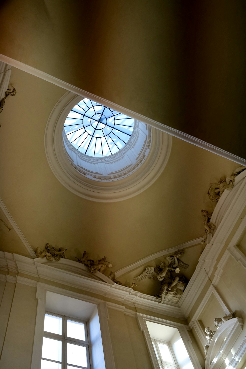 a ceiling with a round window and a skylight