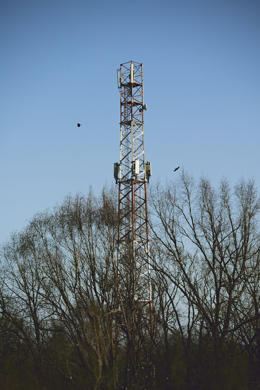 a tall tower with a cell phone on top of it