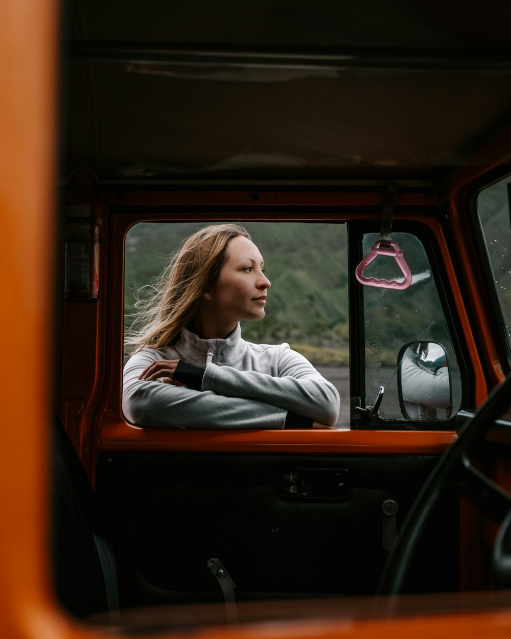 a woman sitting in the drivers seat of a truck