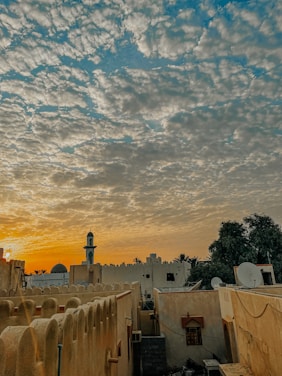 A warm sunset view of the village mosque surrounded by olive trees, symbolizing peace and tradition.