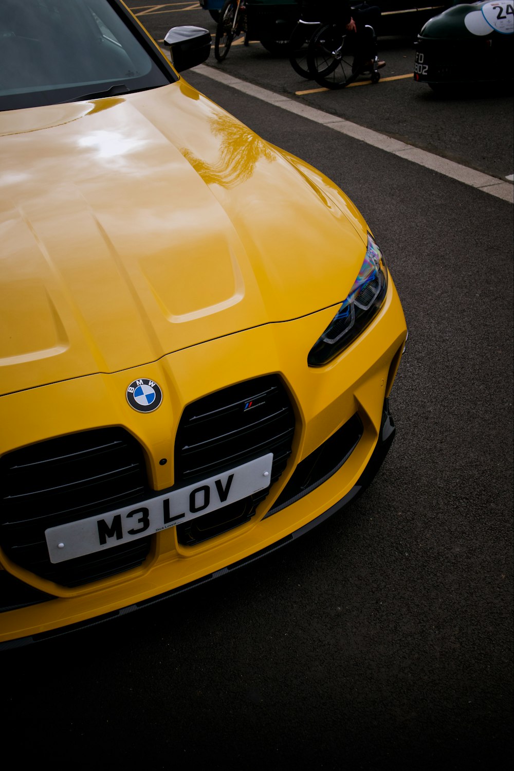 a yellow sports car parked on the side of the road