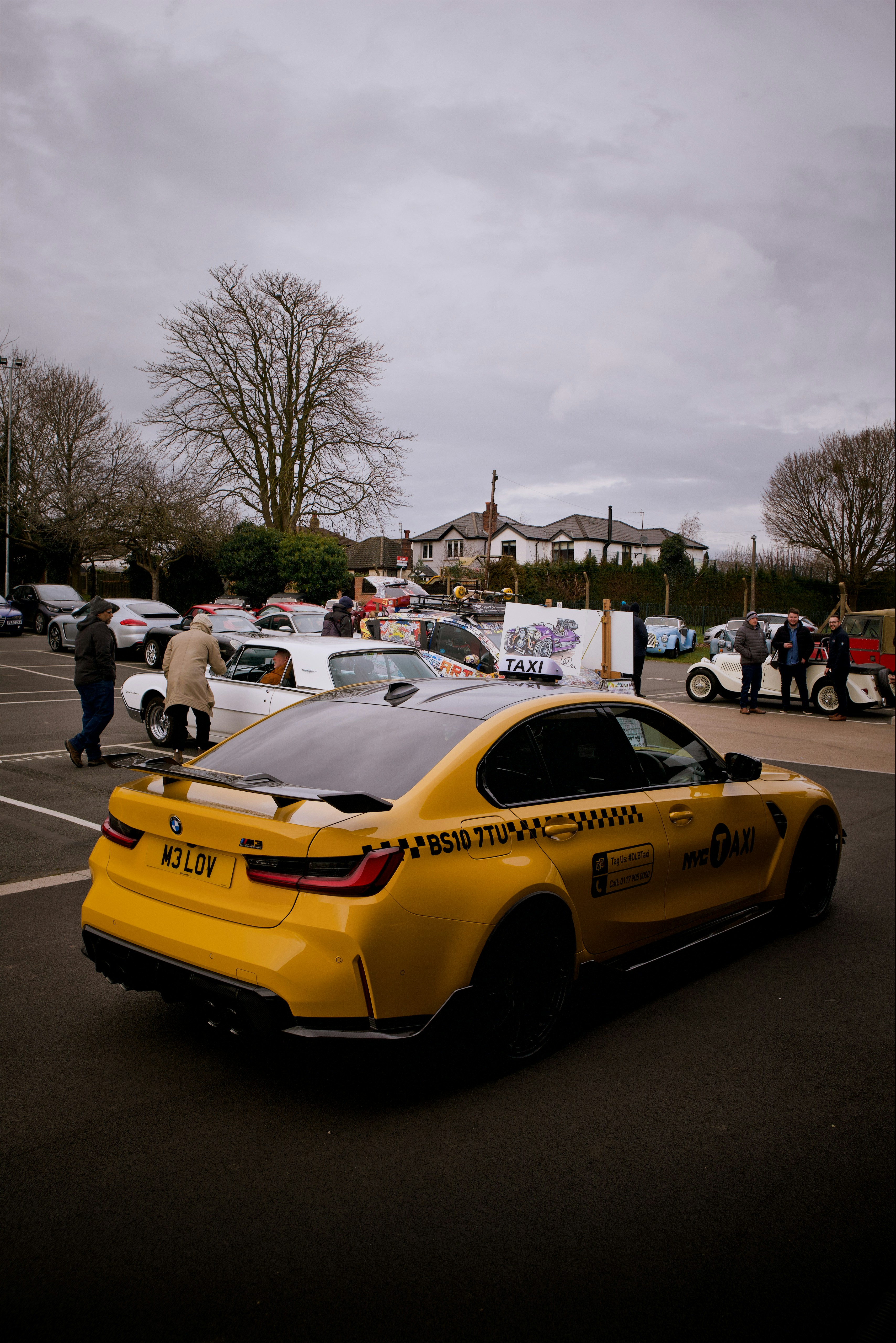 a yellow car parked in a parking lot
