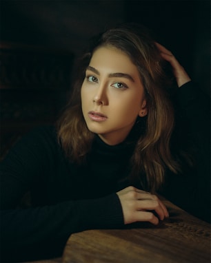 a woman with long hair sitting at a table