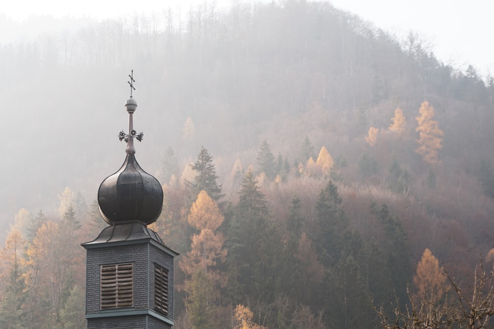 a steeple with a weather vane on top of it