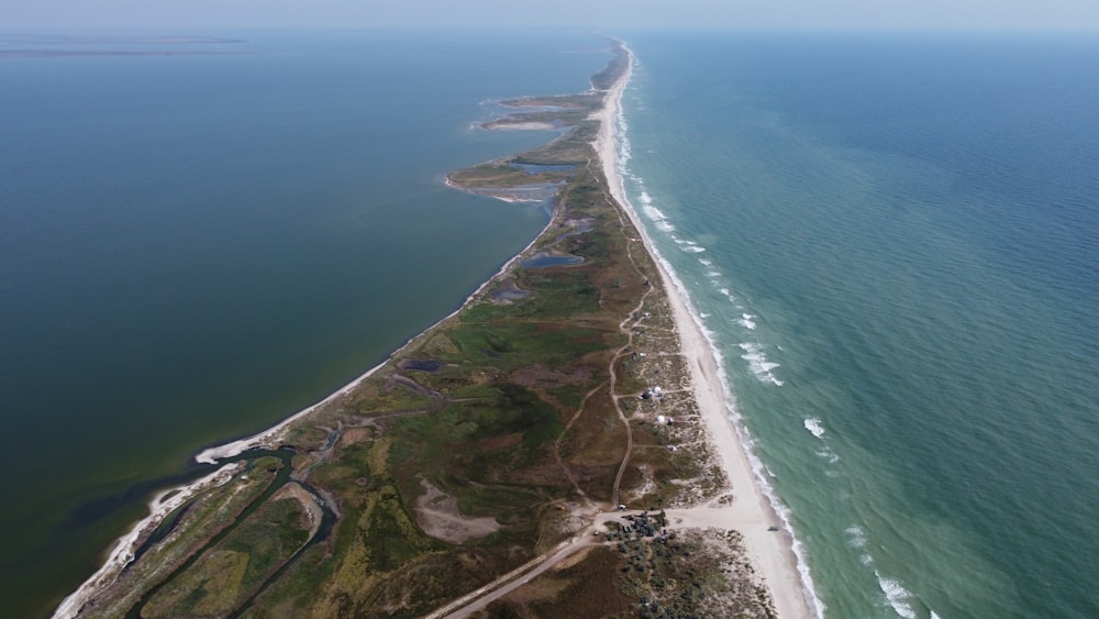 an aerial view of a long stretch of land next to the ocean