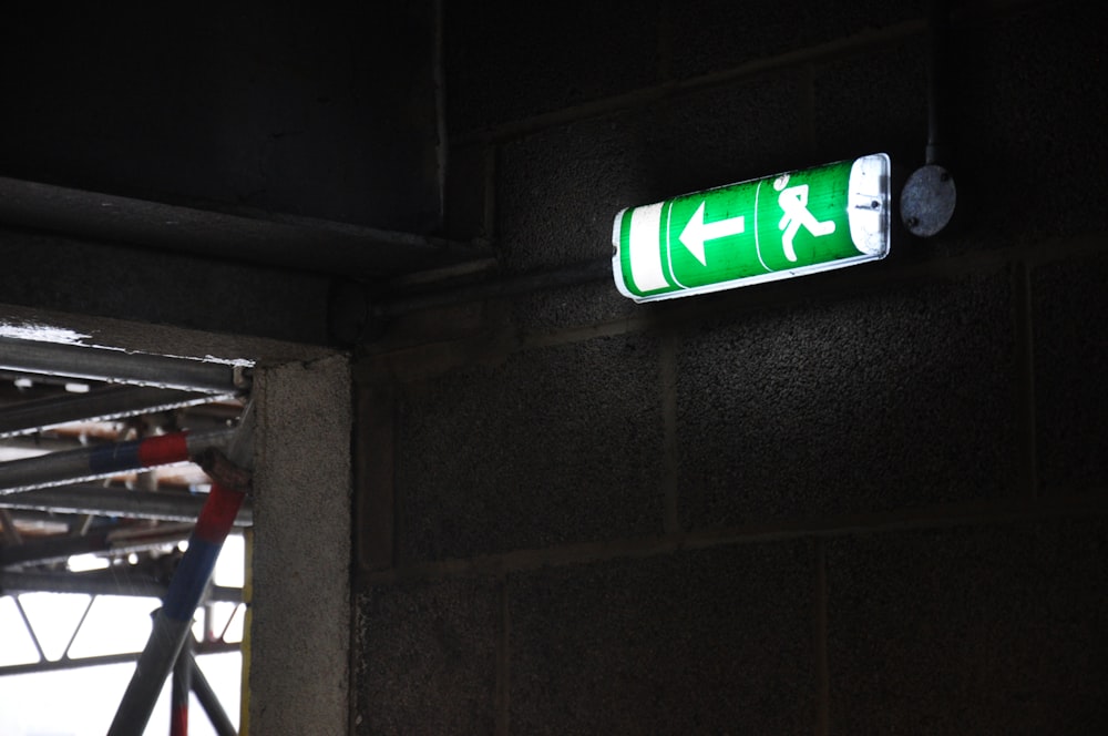 a green sign that is on the side of a building