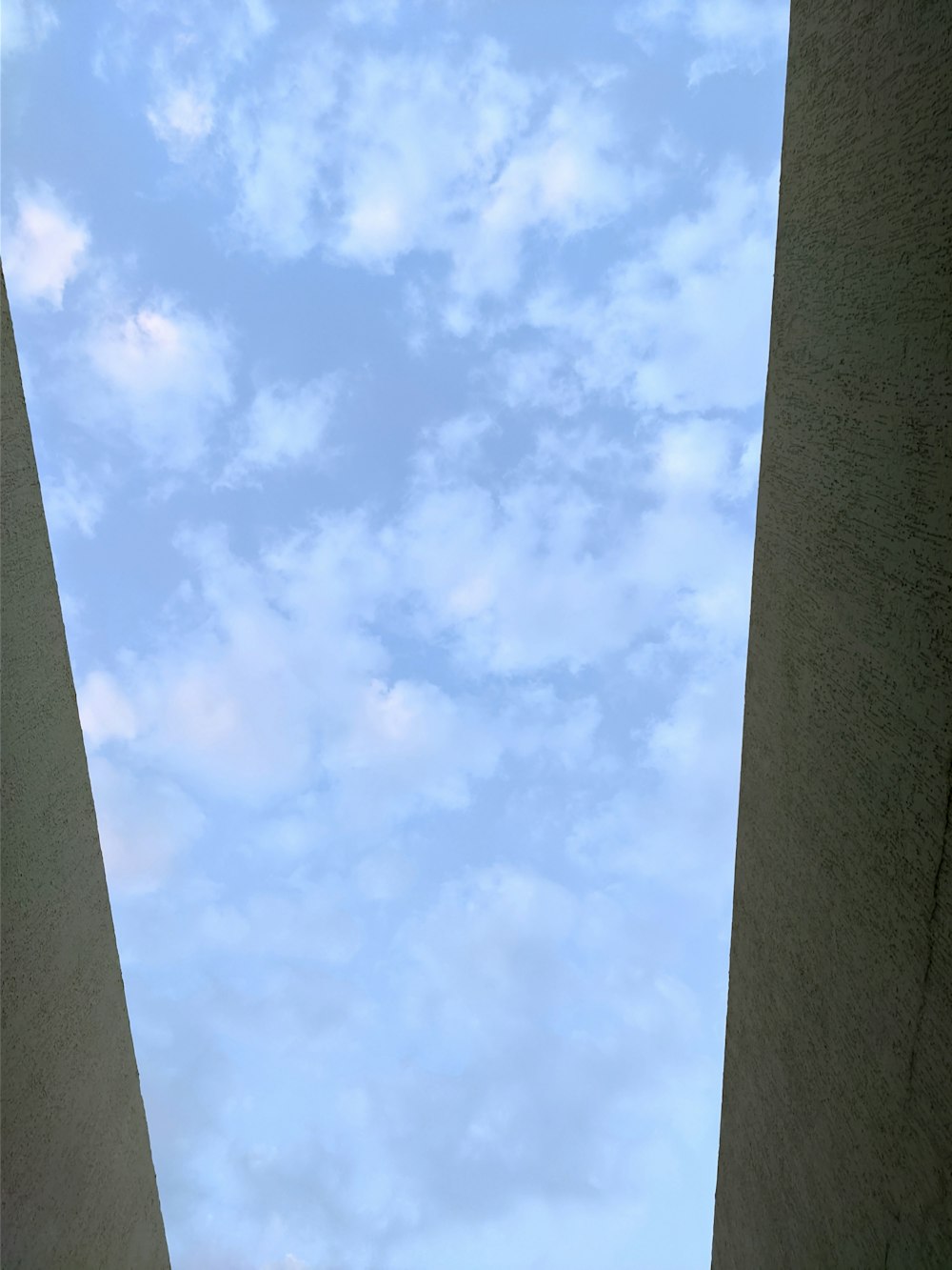 a view of the sky from between two buildings