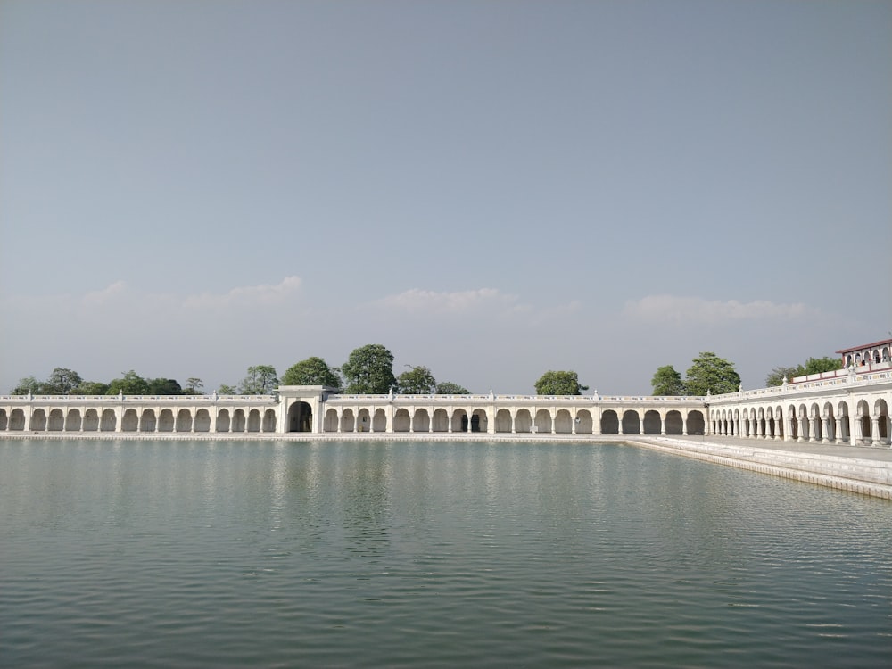 a large body of water next to a white building