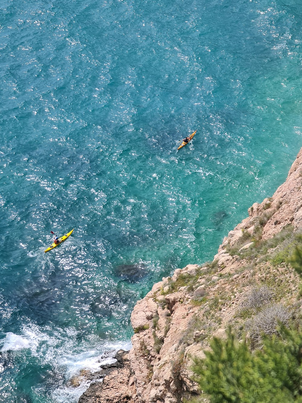 two people are kayaking in the ocean