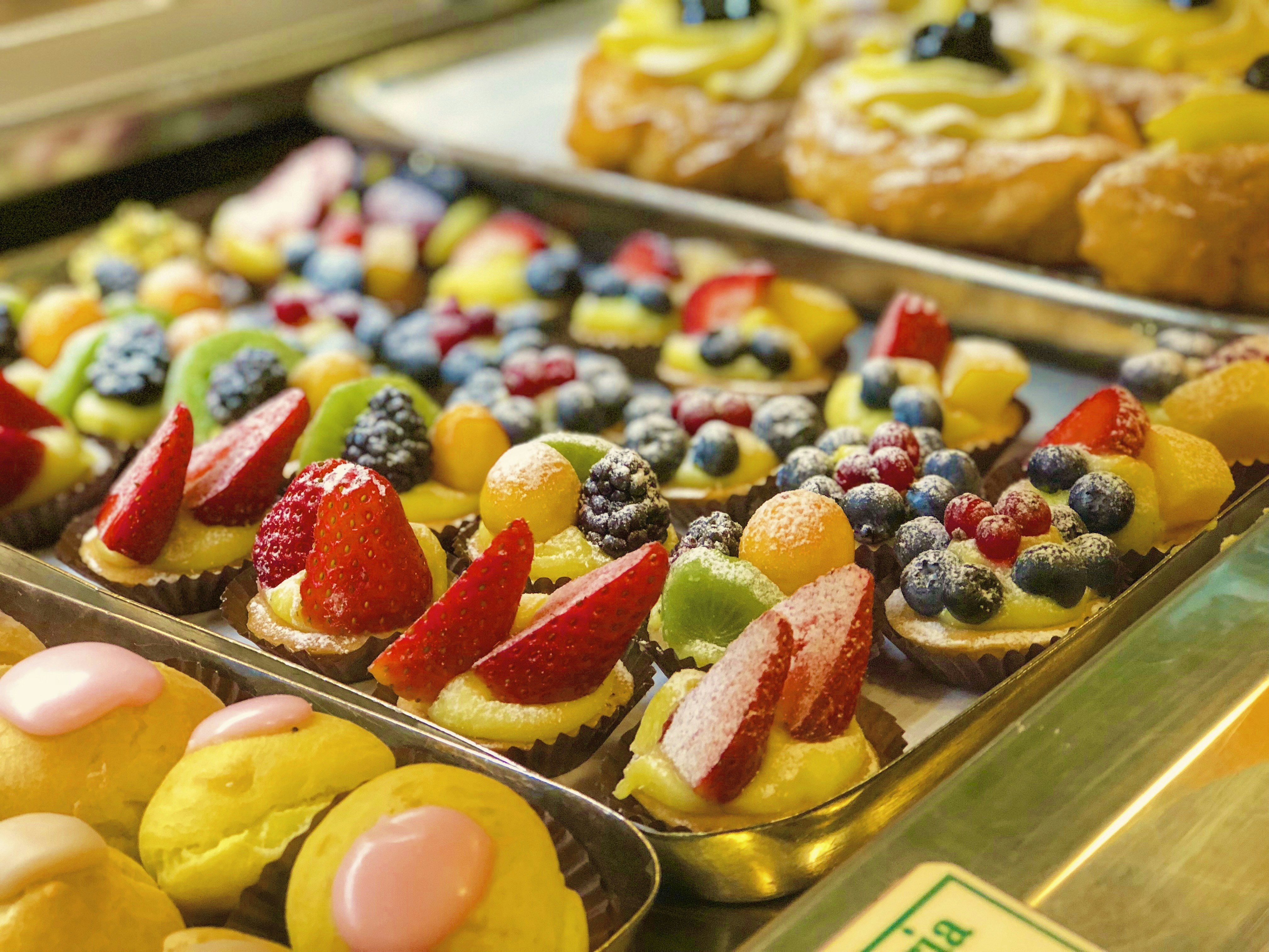 a variety of pastries and desserts are on display, Delights. Rome