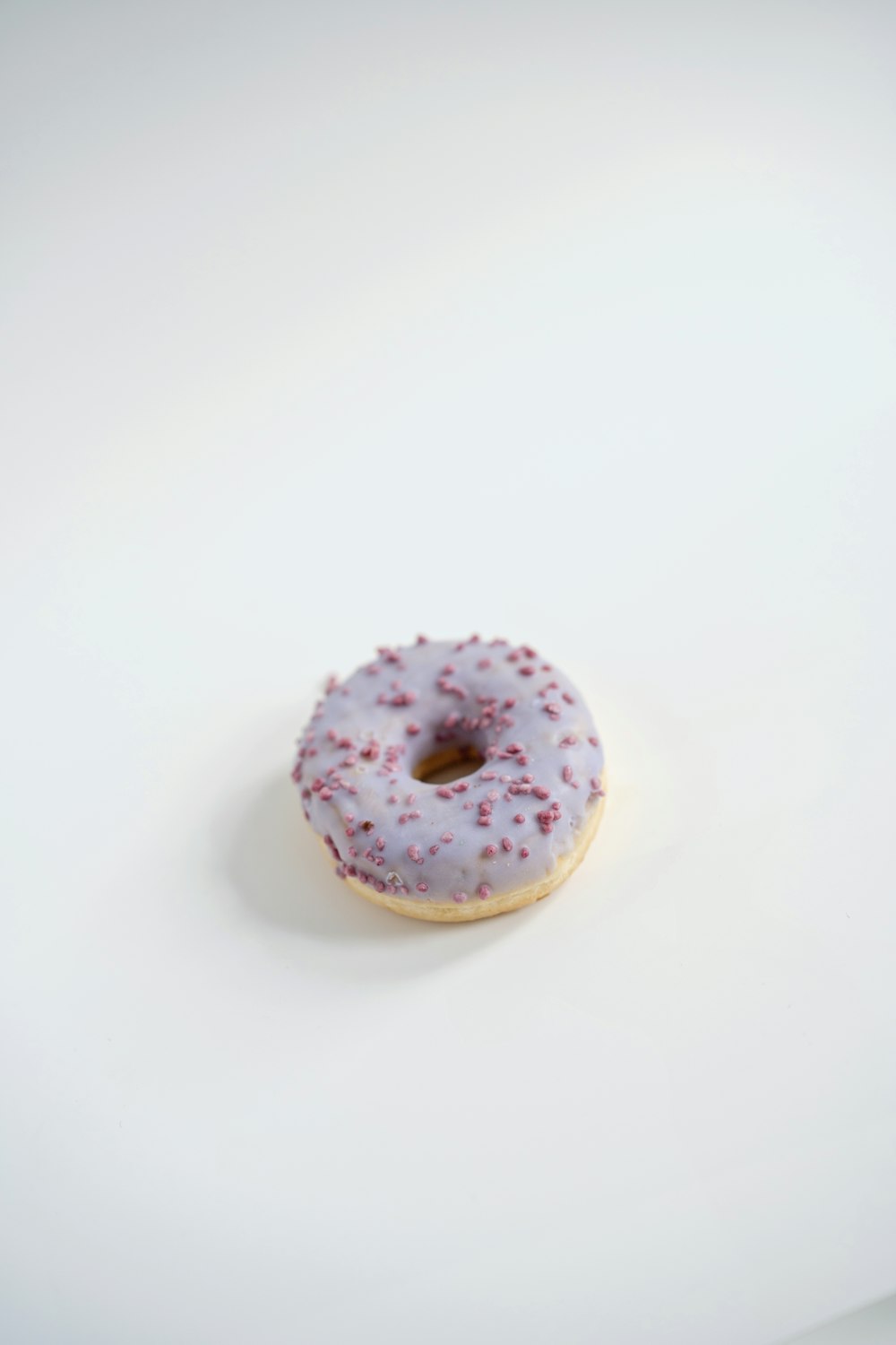 a donut with white icing and sprinkles on it