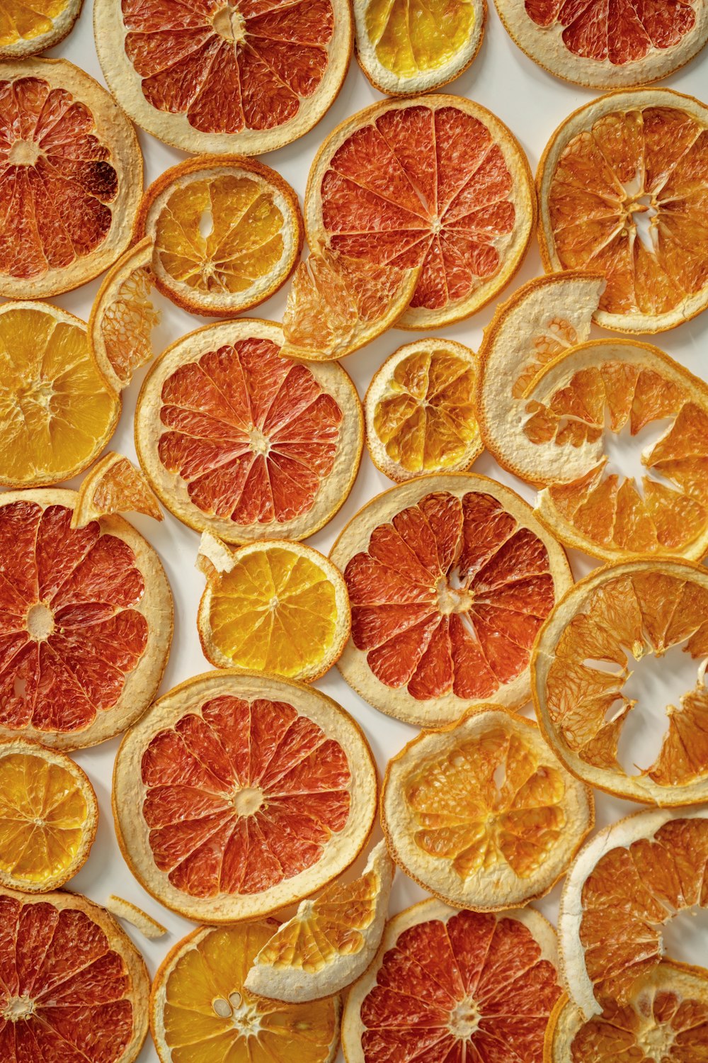 a bunch of oranges cut in half on a table