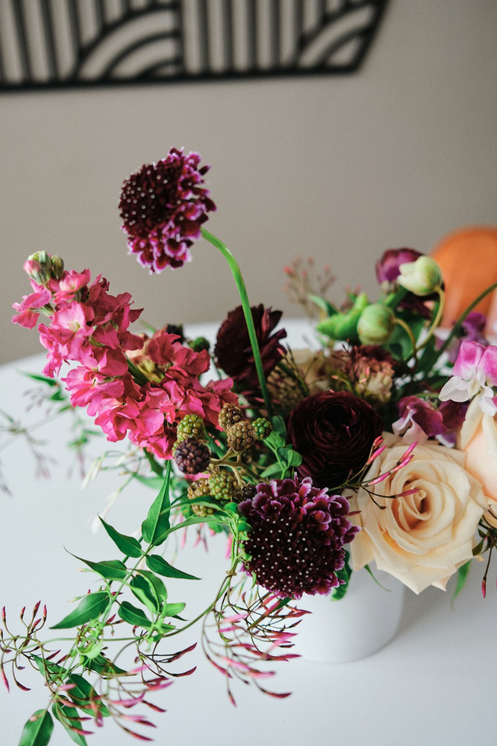 a bouquet of flowers sitting on top of a white table