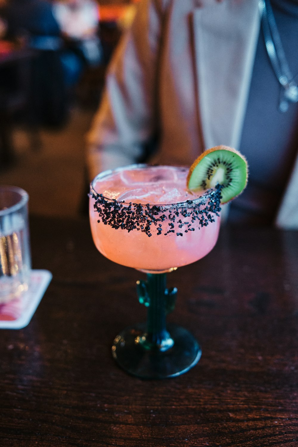 a person sitting at a table with a drink