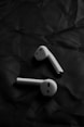 a pair of ear buds sitting on top of a piece of paper