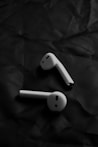 a pair of ear buds sitting on top of a piece of paper