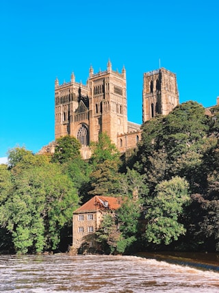 a large building sitting on top of a lush green hillside