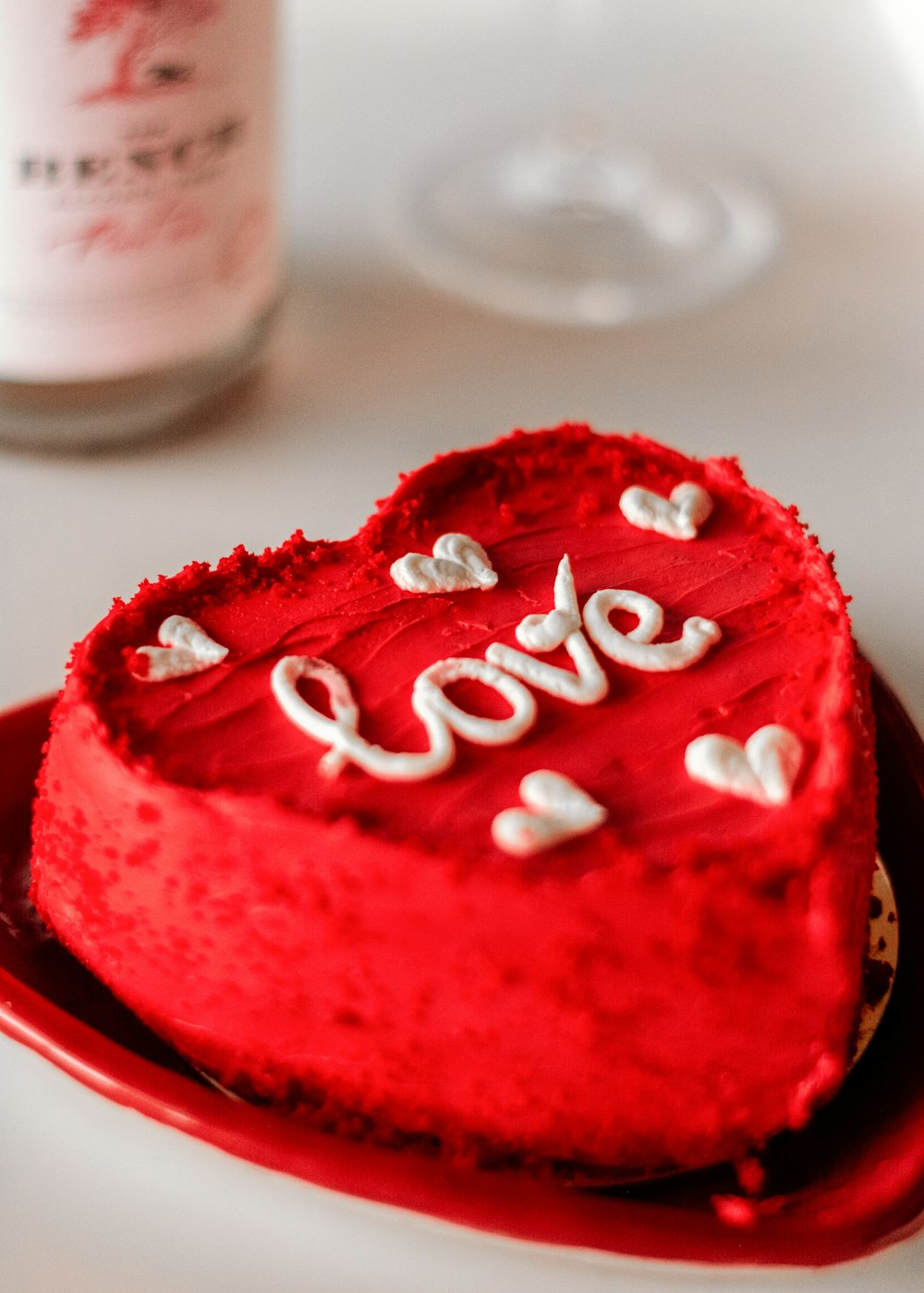 a heart shaped cake sitting on top of a red plate