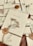 A collection of elegantly wrapped envelopes tied with twine and adorned with dried flowers and wax seals featuring a rose design. The envelopes are arranged casually on a wooden surface, creating a vintage and romantic ambiance.