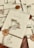 A collection of elegantly wrapped envelopes tied with twine and adorned with dried flowers and wax seals featuring a rose design. The envelopes are arranged casually on a wooden surface, creating a vintage and romantic ambiance.