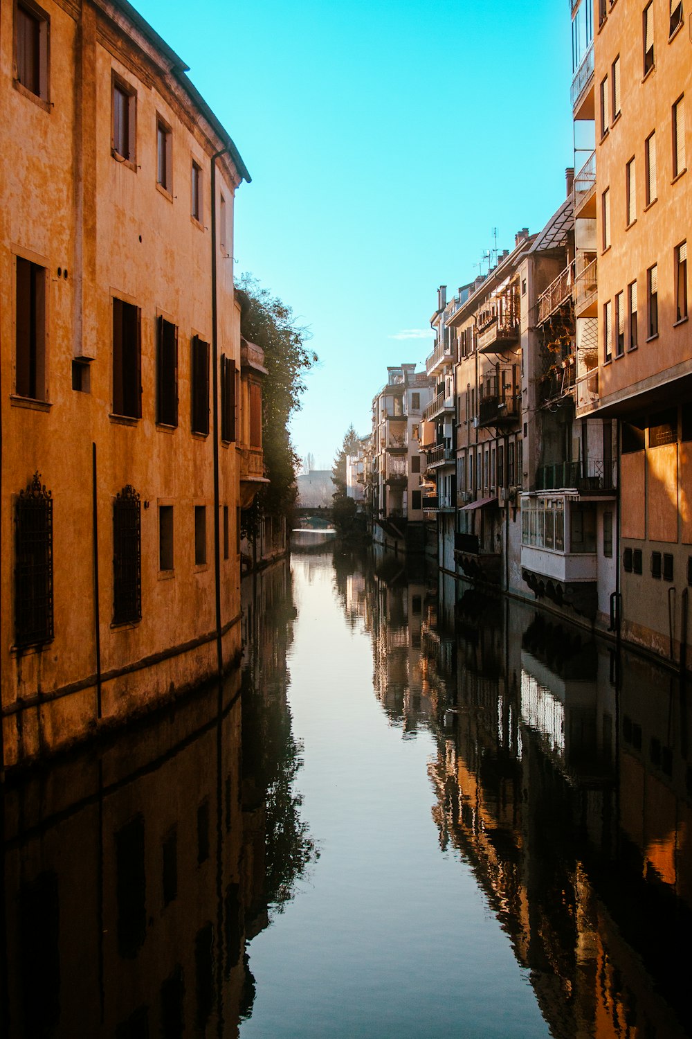 a river running through a city next to tall buildings