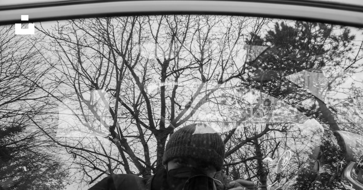 A man taking a picture of himself in a rear view mirror photo – Free ...