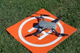 a remote controlled flying device on top of an orange sign