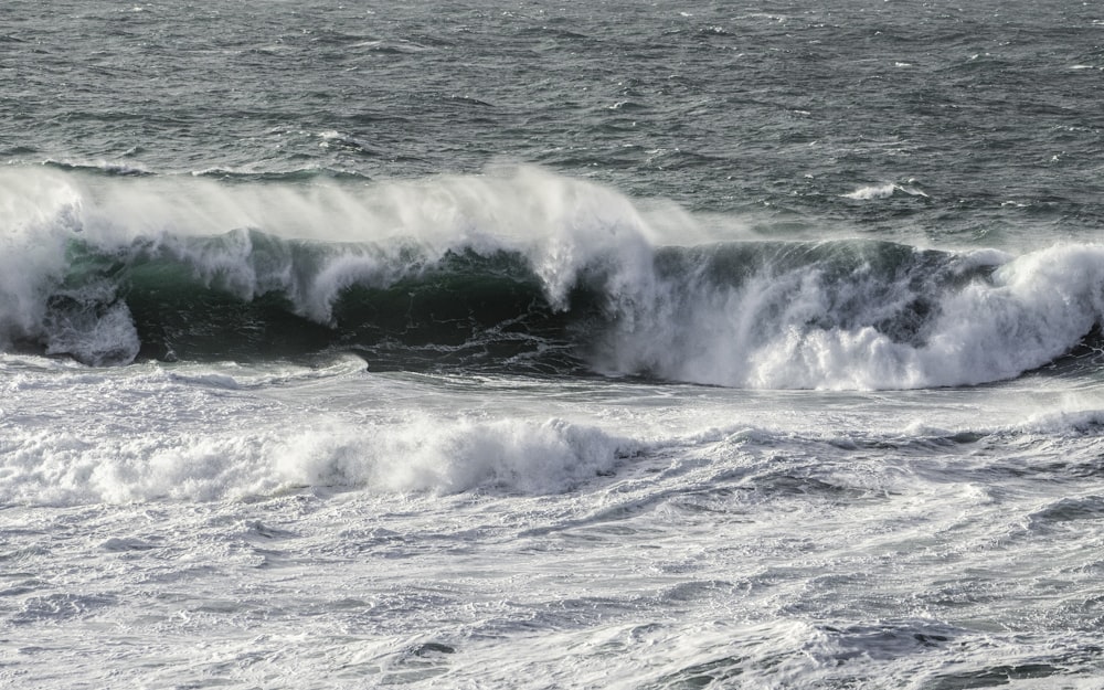 a man riding a wave on top of a body of water