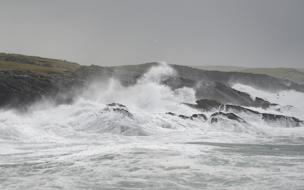 a man riding a wave on top of a body of water