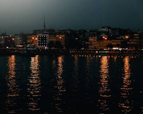 Dark overlay image of Neuquén cityscape at dusk with modern buildings and calm streets.