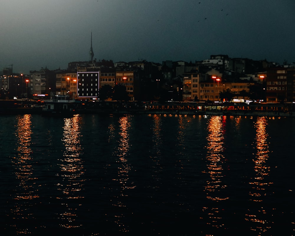 a body of water with a city in the background