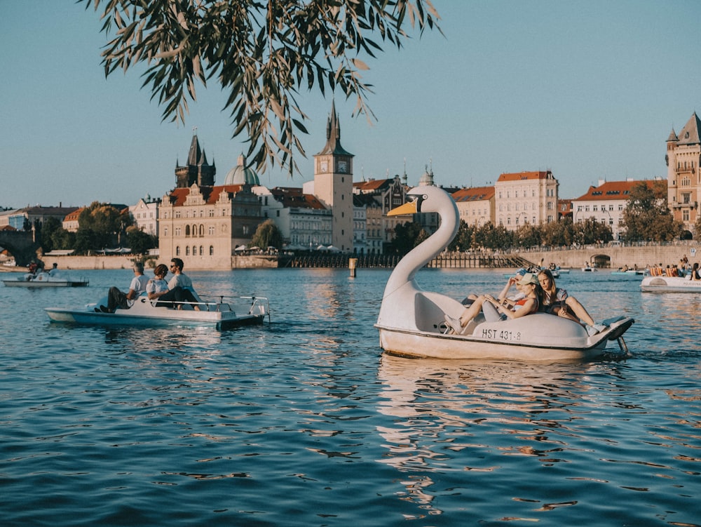 a couple of people riding on a swan shaped boat