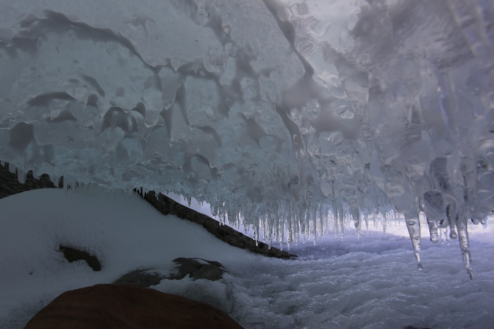 a large ice cave with icicles hanging from the ceiling