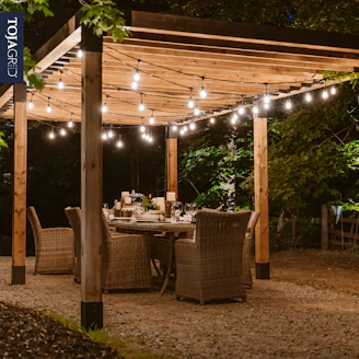 a patio with a table and chairs under a canopy