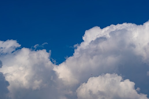 An exciting image of a skydiver maneuvering their canopy in the sky.