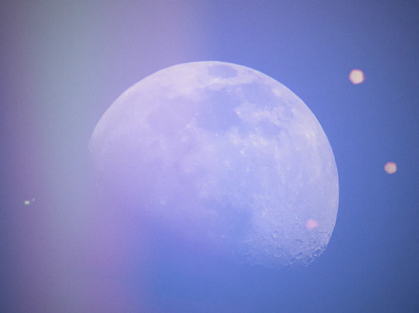 An ethereal video still showing swirling moonlight over textured paper art.