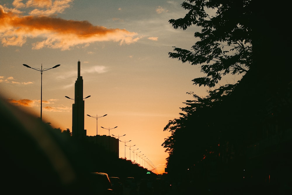 the sun is setting over a city with tall buildings