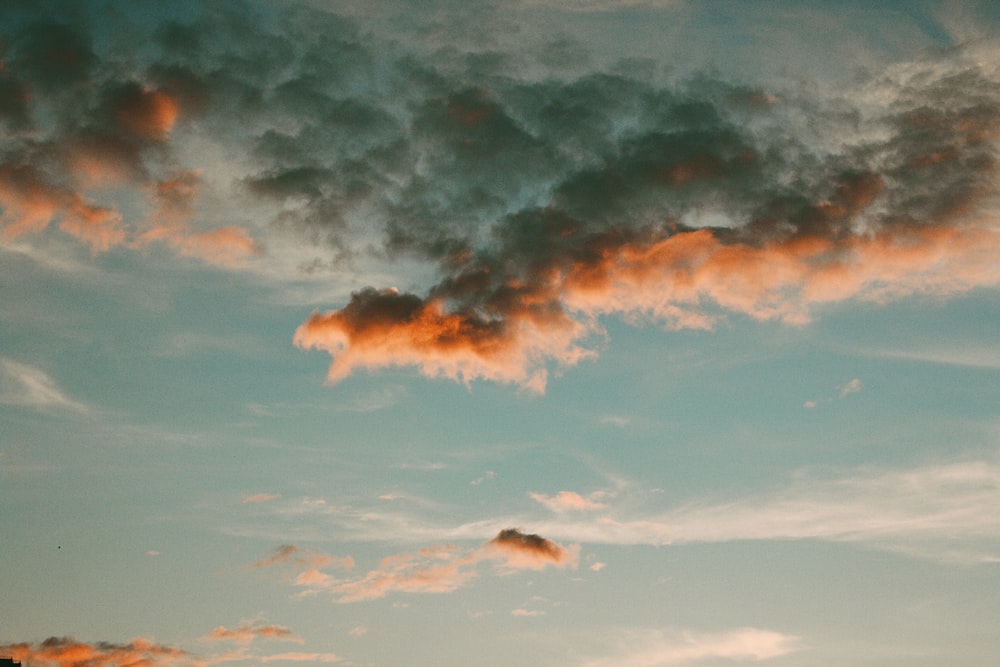 a plane is flying in the sky at sunset