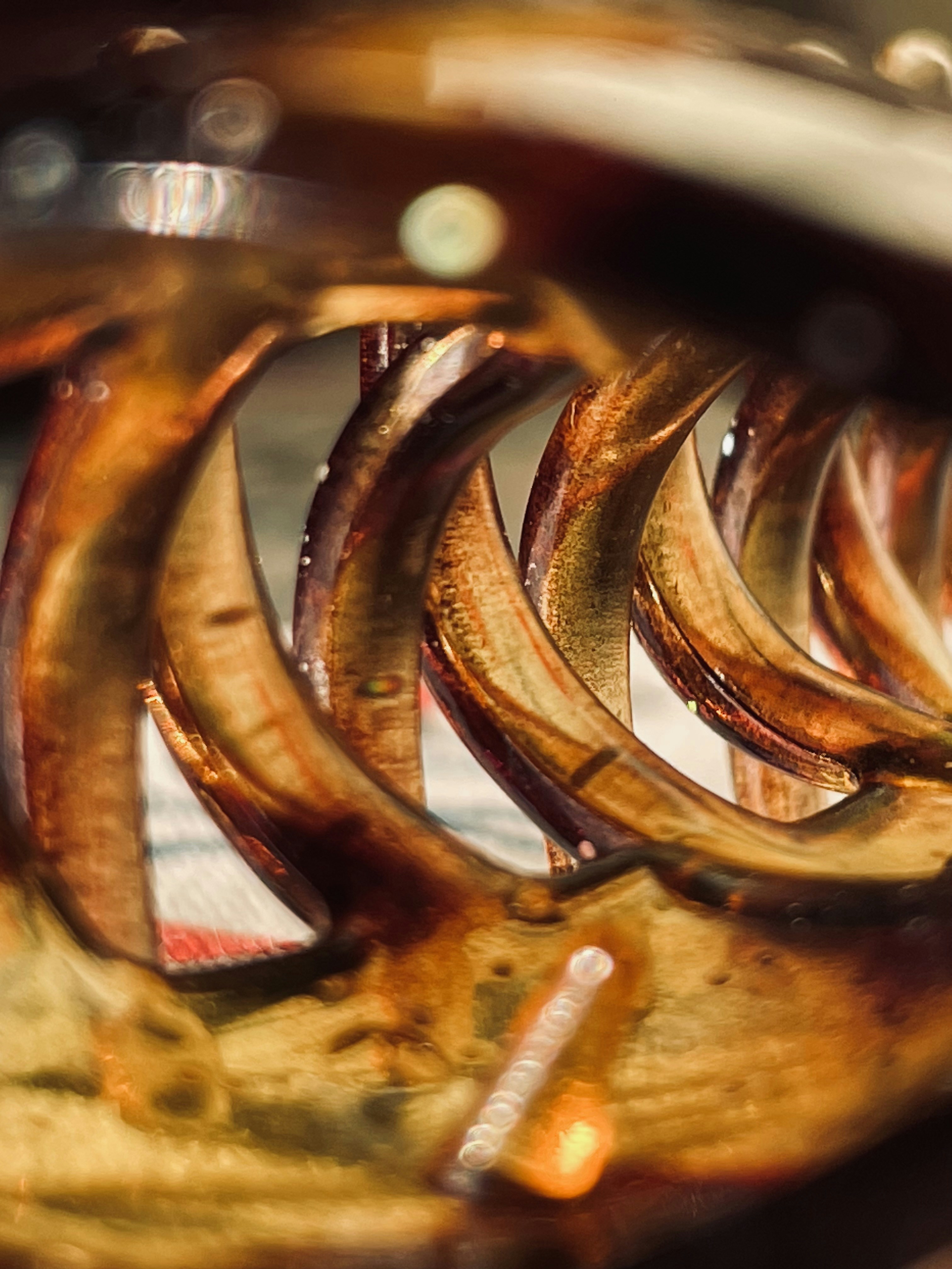 Copper wire cross-section showing bright orange metallic surface, macro photography