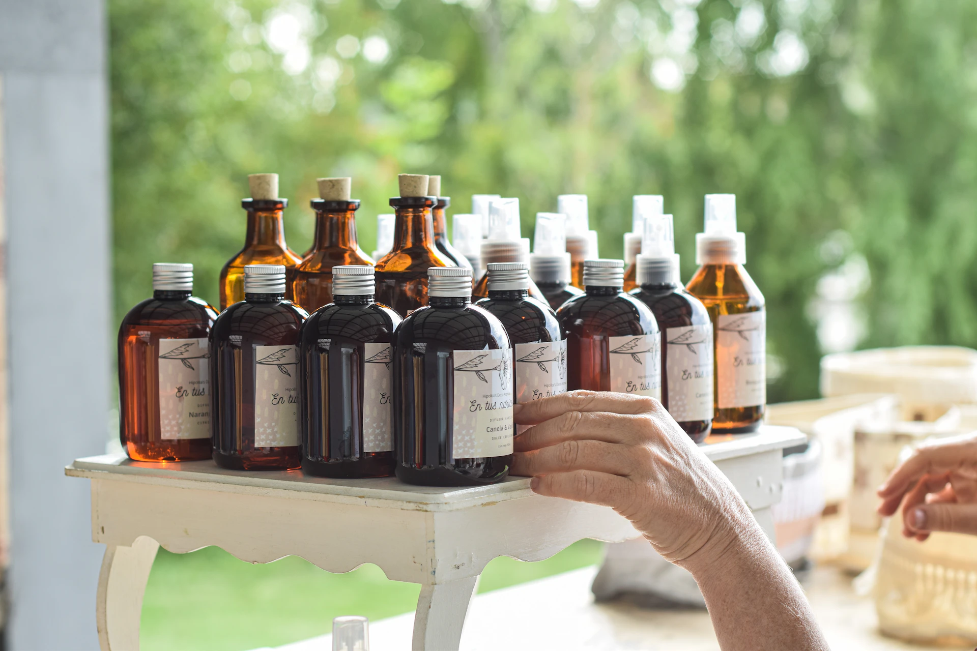 a person holding a tray of bottles of liquid