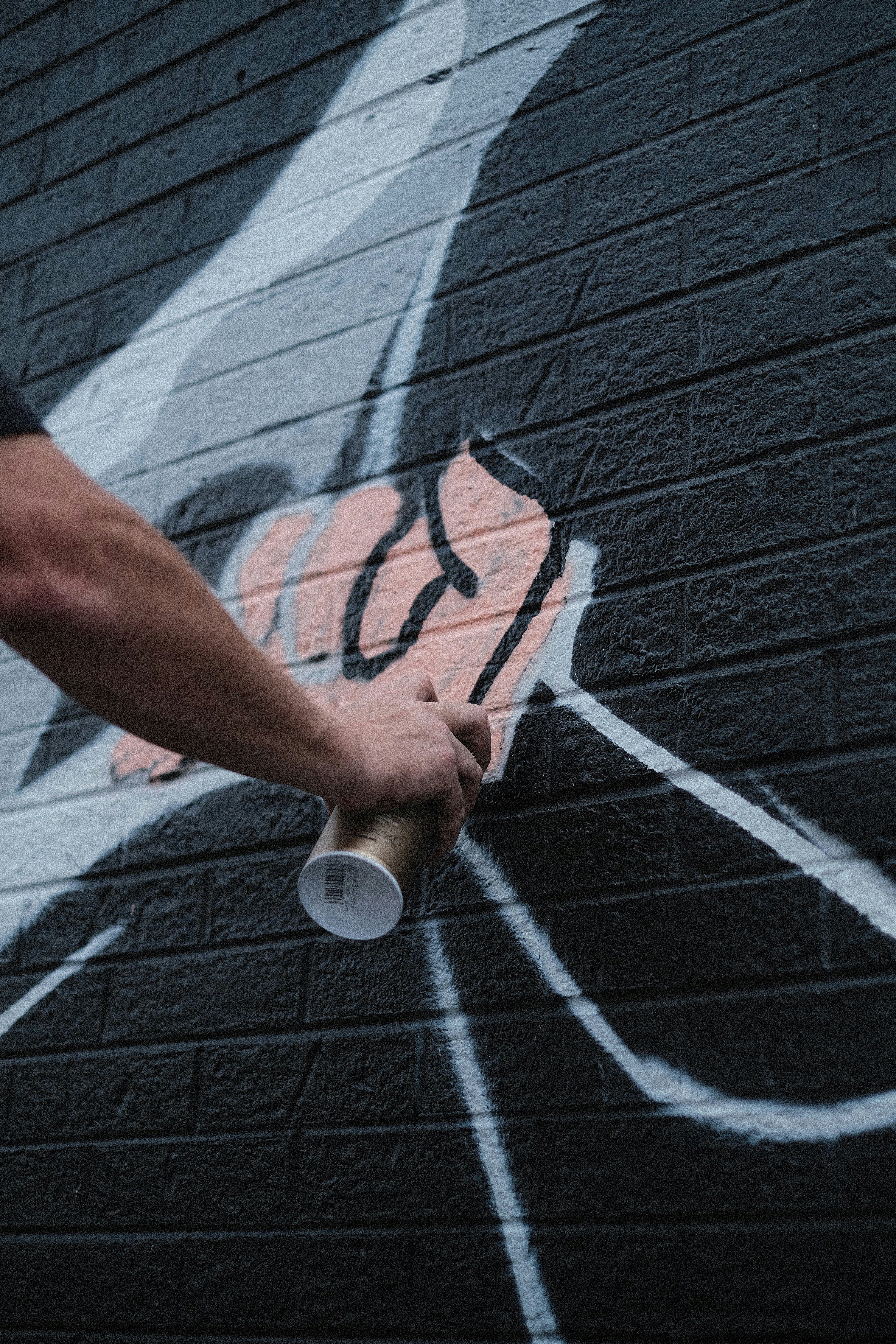 a person is painting a wall with graffiti