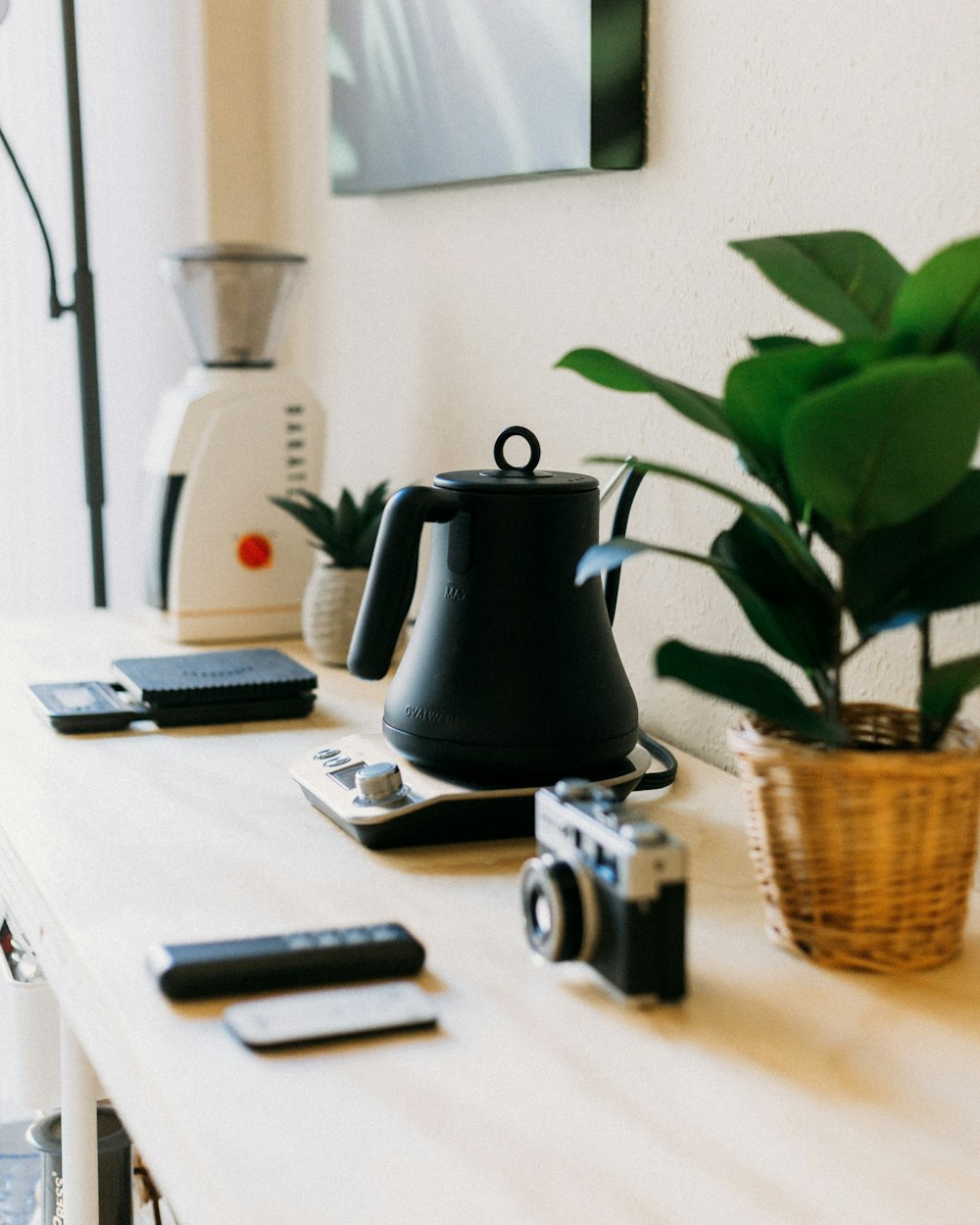 a coffee pot sitting on top of a wooden table