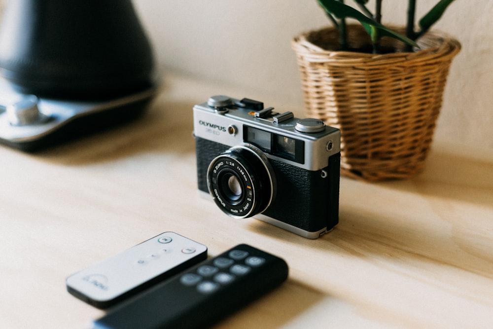 a camera and a remote control on a table