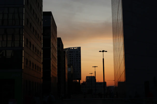 A cinematic frame capturing a sunset cityscape with dynamic lighting and shadows.