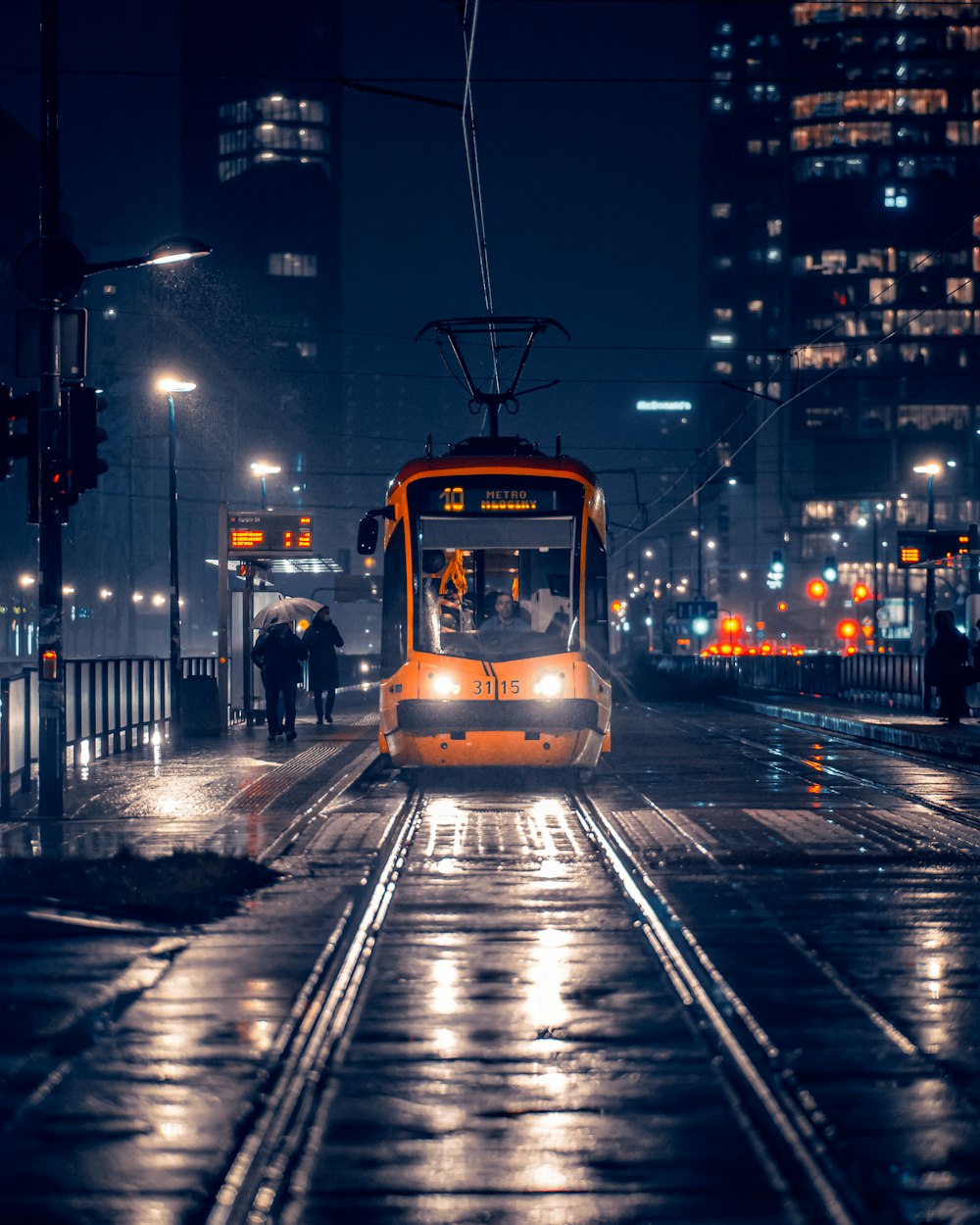 a train on a train track at night